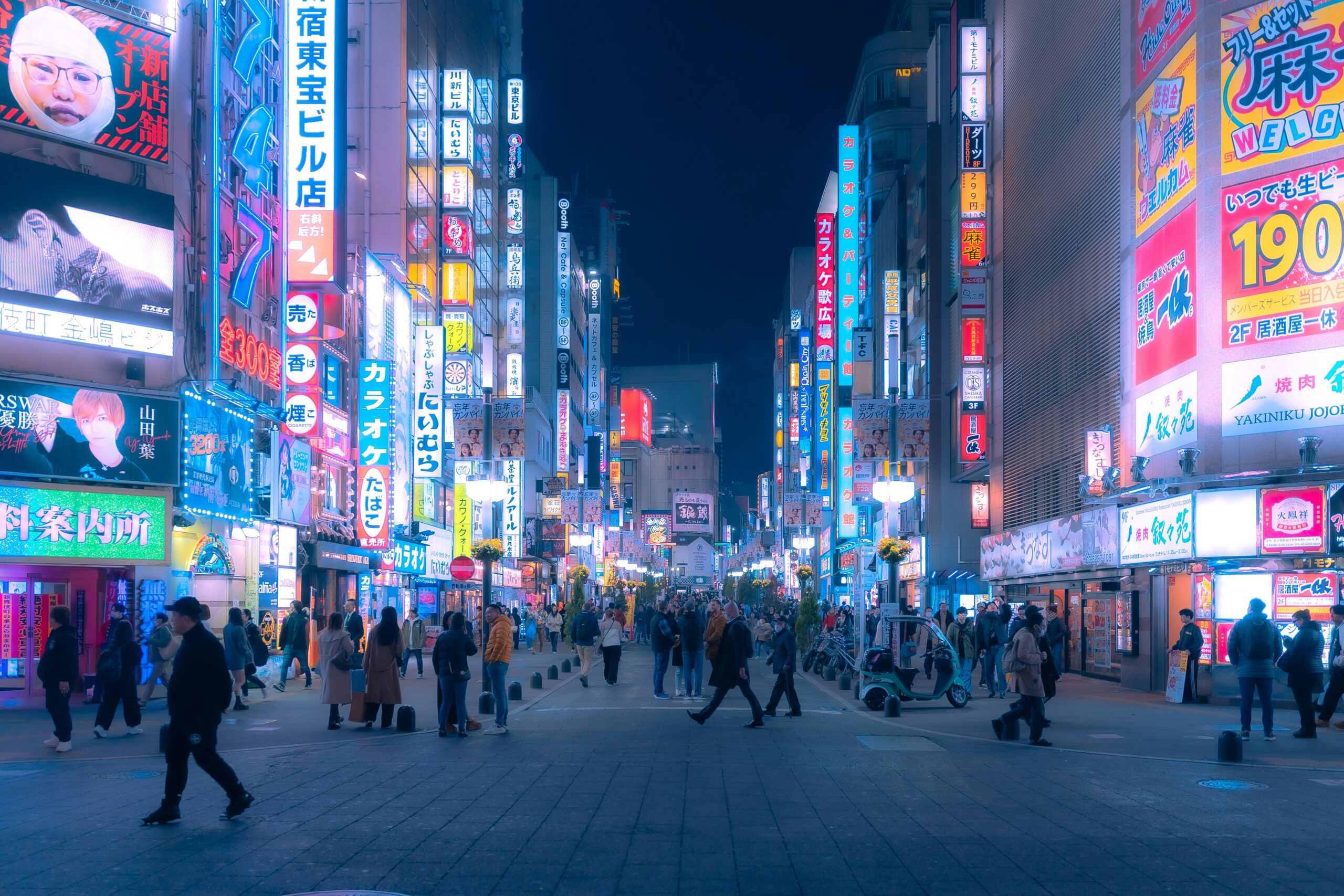Tourists walking through the busy streets of Shinjuku in Tokyo, Japan